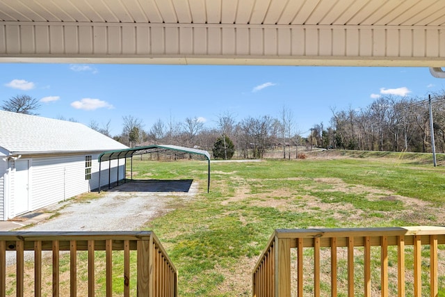 view of yard with driveway and a carport