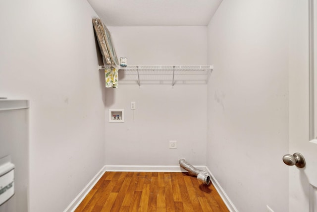 laundry area with hookup for an electric dryer, hookup for a washing machine, baseboards, laundry area, and wood finished floors