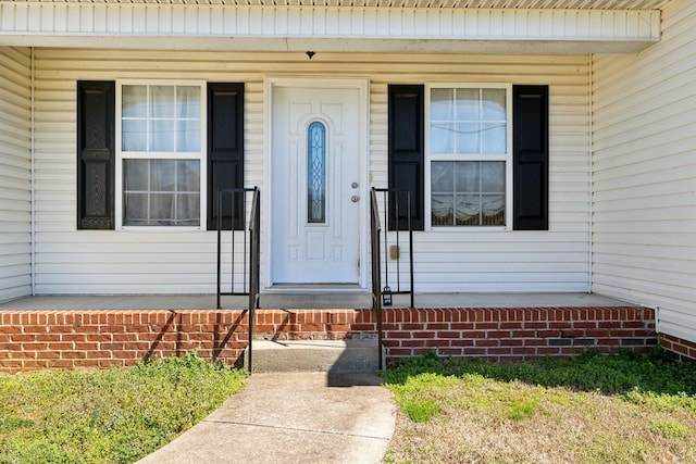 view of exterior entry featuring a porch