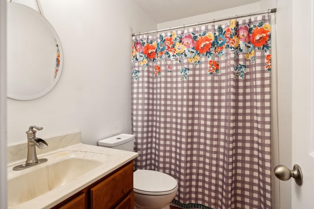 bathroom with a shower with shower curtain, toilet, and vanity