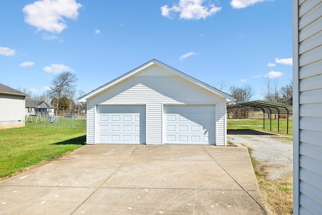 detached garage with fence and a carport
