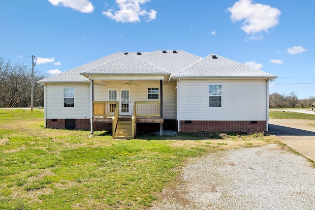 back of house with driveway, crawl space, a ceiling fan, a shingled roof, and a yard