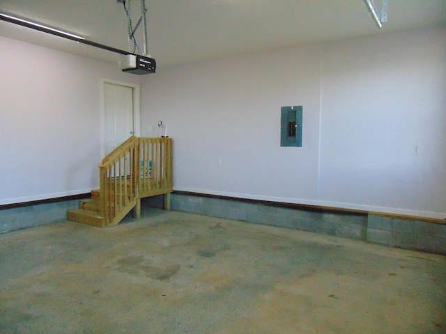 garage with electric panel and a garage door opener