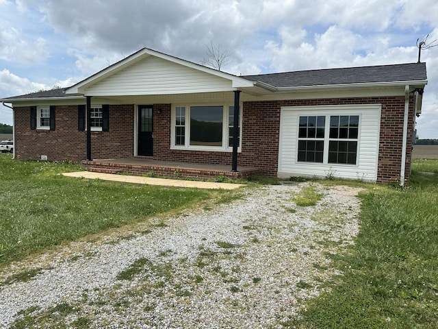 59 Overnack Rd, Lawrenceburg, TN 38464 - ranch-style home featuring covered porch, brick siding, and a front yard