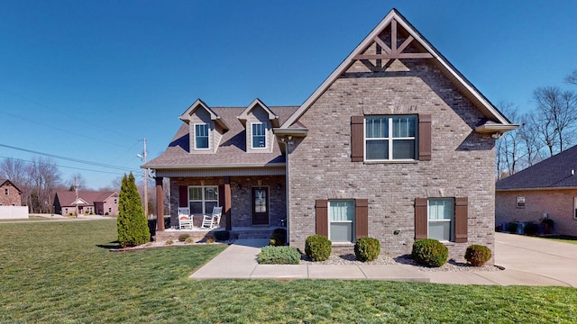 5020 E Mayflower Ct, Greenbrier, TN 37073 - view of front of property with brick siding, a porch, and a front lawn