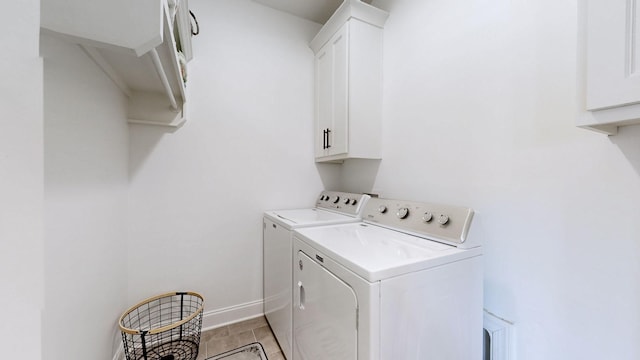 5020 E Mayflower Ct, Greenbrier, TN 37073 - washroom featuring cabinet space, light tile patterned floors, washing machine and dryer, and baseboards