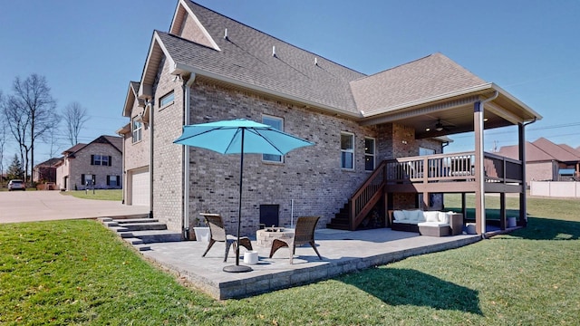 5020 E Mayflower Ct, Greenbrier, TN 37073 - back of property featuring a patio, roof with shingles, a yard, stairs, and brick siding