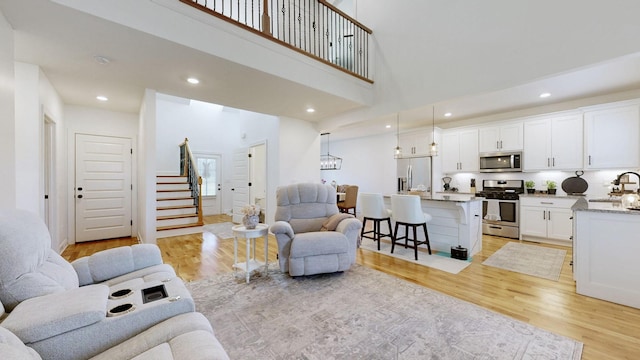 5020 E Mayflower Ct, Greenbrier, TN 37073 - living room featuring stairs, recessed lighting, and light wood-type flooring