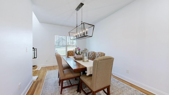 5020 E Mayflower Ct, Greenbrier, TN 37073 - dining area featuring baseboards, a notable chandelier, and light wood-style flooring