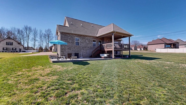 5020 E Mayflower Ct, Greenbrier, TN 37073 - rear view of house featuring brick siding, a wooden deck, stairs, a yard, and a patio