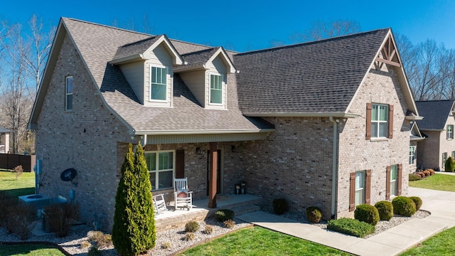 5020 E Mayflower Ct, Greenbrier, TN 37073 - view of front of home with a front yard, covered porch, and a shingled roof