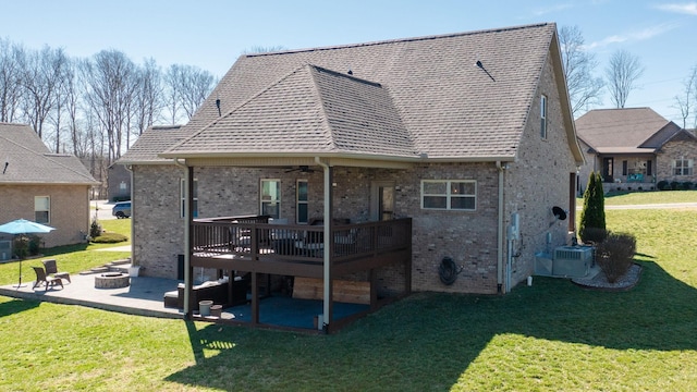 5020 E Mayflower Ct, Greenbrier, TN 37073 - back of house with a lawn, a fire pit, a wooden deck, brick siding, and a patio area