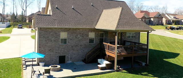 5020 E Mayflower Ct, Greenbrier, TN 37073 - rear view of property with a lawn, an outdoor fire pit, roof with shingles, a wooden deck, and a patio area