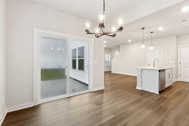 4228 Skyridge Dr, Nashville, TN 37207 - kitchen with stainless steel dishwasher, dark wood finished floors, a chandelier, a kitchen island with sink, and light countertops