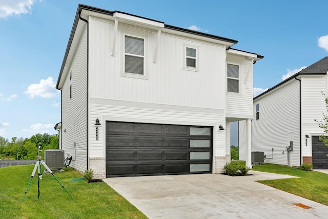 4228 Skyridge Dr, Nashville, TN 37207 - view of front of property with an attached garage, central air condition unit, driveway, and a front lawn
