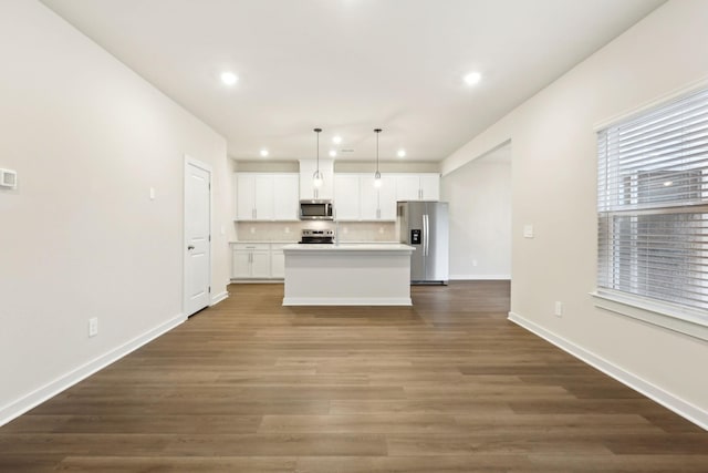 4228 Skyridge Dr, Nashville, TN 37207 - kitchen with stainless steel appliances, recessed lighting, white cabinets, an island with sink, and baseboards