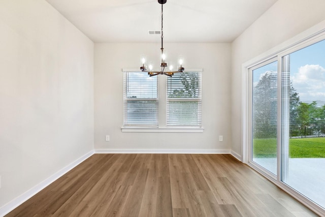 4228 Skyridge Dr, Nashville, TN 37207 - unfurnished dining area with a chandelier, wood finished floors, healthy amount of natural light, and baseboards