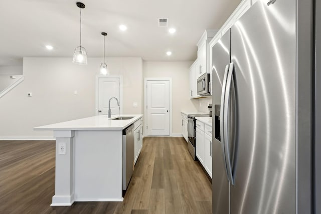 4228 Skyridge Dr, Nashville, TN 37207 - kitchen featuring stainless steel appliances, a sink, a kitchen island with sink, dark wood-style floors, and white cabinetry