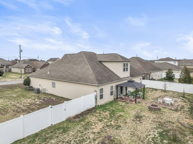 1060 Campbell Ave, Gallatin, TN 37066 - rear view of house with a shingled roof, an outdoor fire pit, central AC, a gazebo, and a fenced backyard