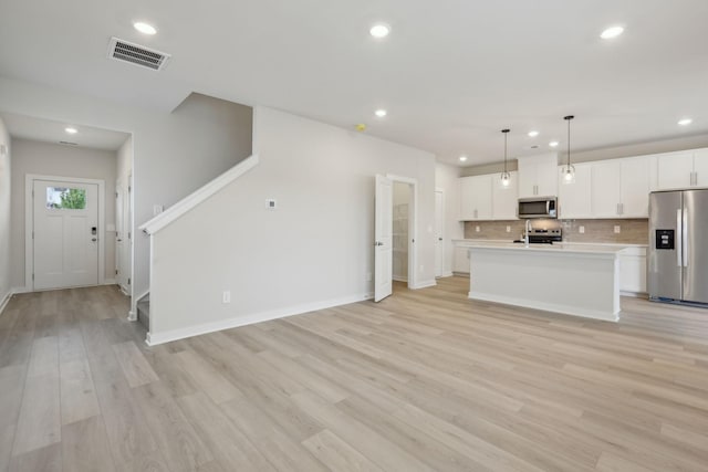 4220 Skyridge Dr, Nashville, TN 37207 - kitchen with appliances with stainless steel finishes, light countertops, recessed lighting, backsplash, and light wood-style flooring