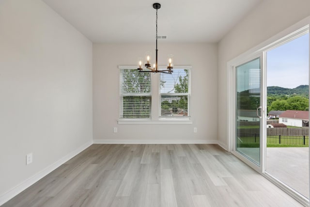 4220 Skyridge Dr, Nashville, TN 37207 - unfurnished dining area with a chandelier, light wood finished floors, and baseboards