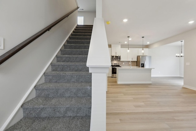 4220 Skyridge Dr, Nashville, TN 37207 - stairs featuring wood finished floors, recessed lighting, baseboards, and a chandelier