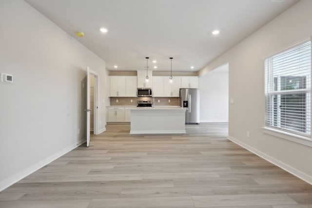 4220 Skyridge Dr, Nashville, TN 37207 - kitchen featuring stainless steel appliances, recessed lighting, open floor plan, backsplash, and white cabinets