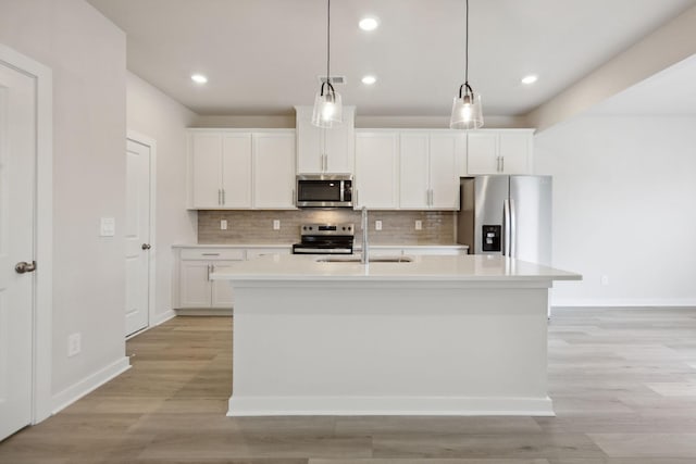 4220 Skyridge Dr, Nashville, TN 37207 - kitchen featuring appliances with stainless steel finishes, a sink, light countertops, backsplash, and white cabinetry