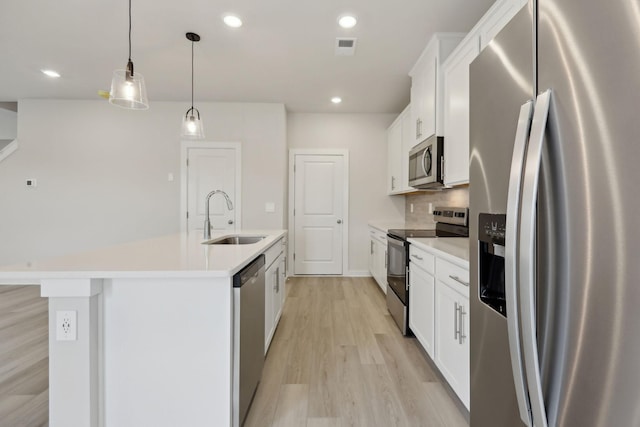 4220 Skyridge Dr, Nashville, TN 37207 - kitchen with stainless steel appliances, a sink, light countertops, a kitchen island with sink, and white cabinets