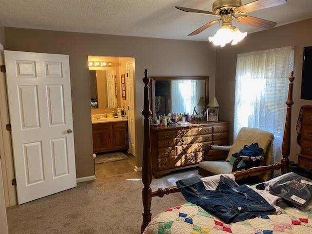 1306 Mcmahan St, Manchester, TN 37355 - carpeted bedroom featuring connected bathroom and a sink
