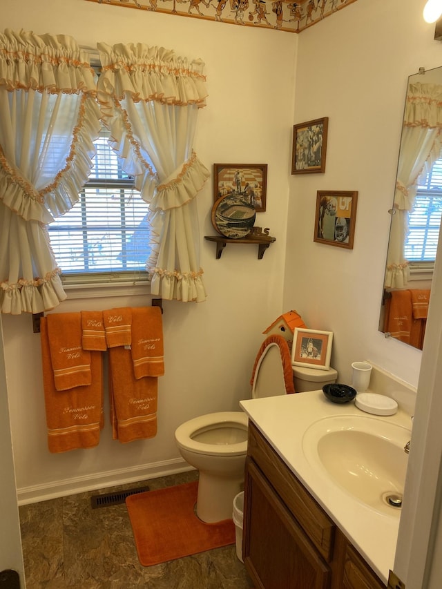 1306 Mcmahan St, Manchester, TN 37355 - bathroom with vanity, toilet, stone finish floors, and baseboards