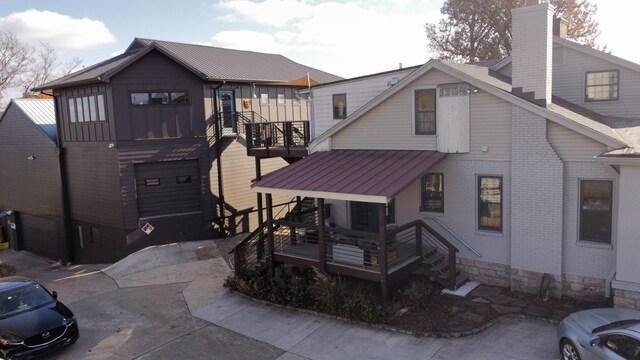 2606 Westwood Dr, Nashville, TN 37204 - rear view of property featuring a balcony, driveway, a standing seam roof, brick siding, and metal roof