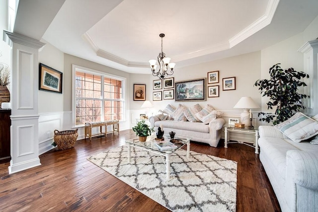 908 Plantation Blvd, Gallatin, TN 37066 - living area featuring a wainscoted wall, dark wood-type flooring, a notable chandelier, decorative columns, and a raised ceiling