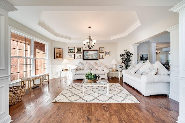 908 Plantation Blvd, Gallatin, TN 37066 - living area featuring dark wood-style floors, a tray ceiling, ornamental molding, a decorative wall, and a notable chandelier