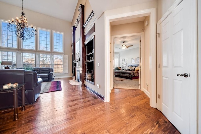 908 Plantation Blvd, Gallatin, TN 37066 - entrance foyer featuring a towering ceiling, ceiling fan with notable chandelier, baseboards, and wood-type flooring