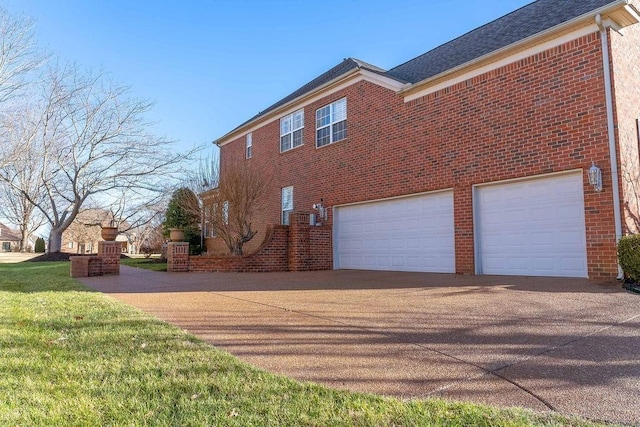 908 Plantation Blvd, Gallatin, TN 37066 - view of home's exterior featuring a garage, brick siding, and concrete driveway