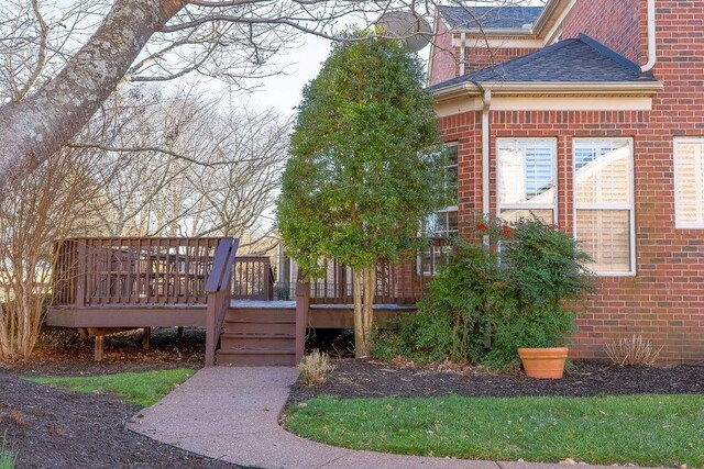 908 Plantation Blvd, Gallatin, TN 37066 - view of side of home featuring brick siding, a deck, and roof with shingles