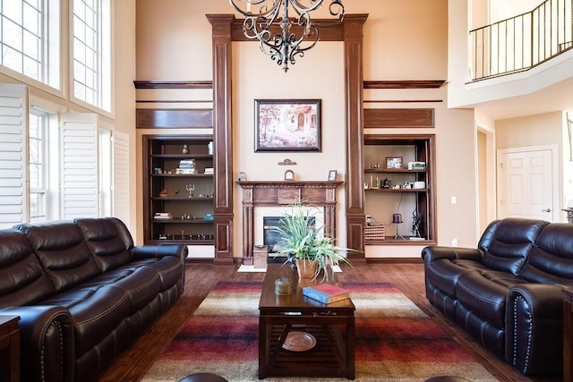 908 Plantation Blvd, Gallatin, TN 37066 - living room featuring a chandelier, built in shelves, dark wood-type flooring, and a towering ceiling