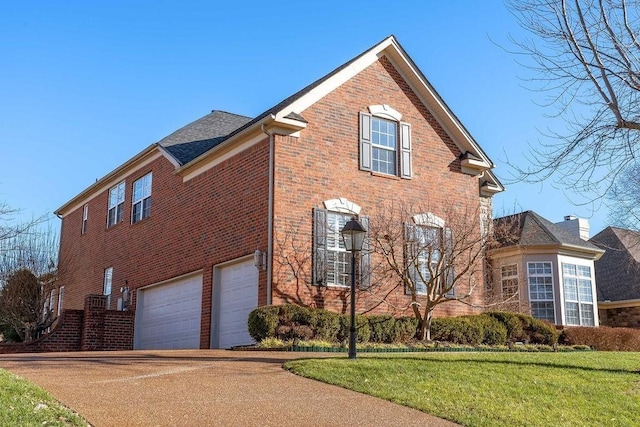 908 Plantation Blvd, Gallatin, TN 37066 - view of property exterior with concrete driveway, brick siding, and a garage