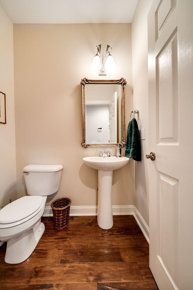 908 Plantation Blvd, Gallatin, TN 37066 - bathroom with baseboards, toilet, and wood finished floors