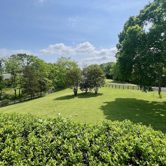 view of yard featuring fence and a rural view