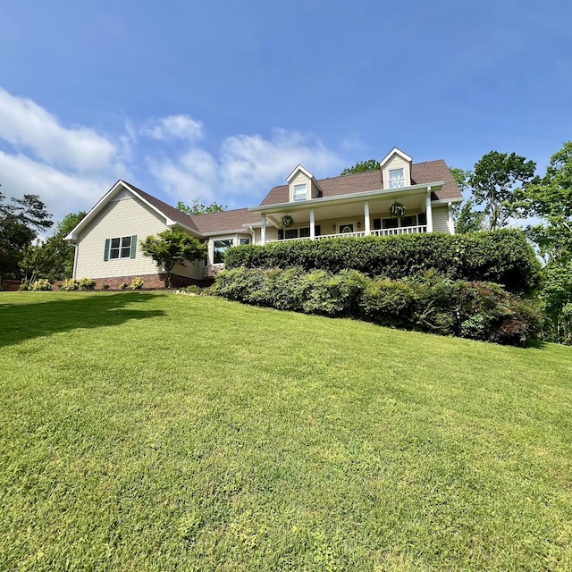 cape cod-style house with a front lawn