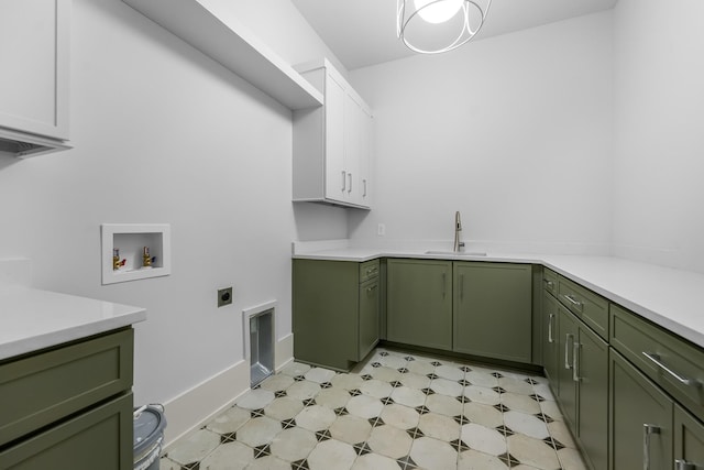 washroom with light floors, hookup for a washing machine, cabinet space, electric dryer hookup, and a sink