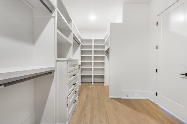 walk in closet featuring light wood finished floors