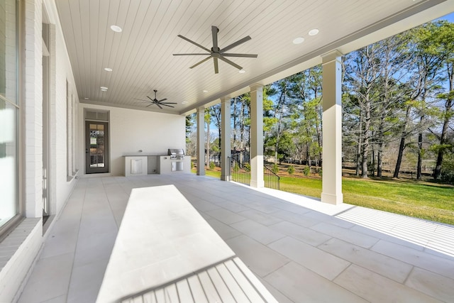 view of patio / terrace with area for grilling, a grill, and a ceiling fan