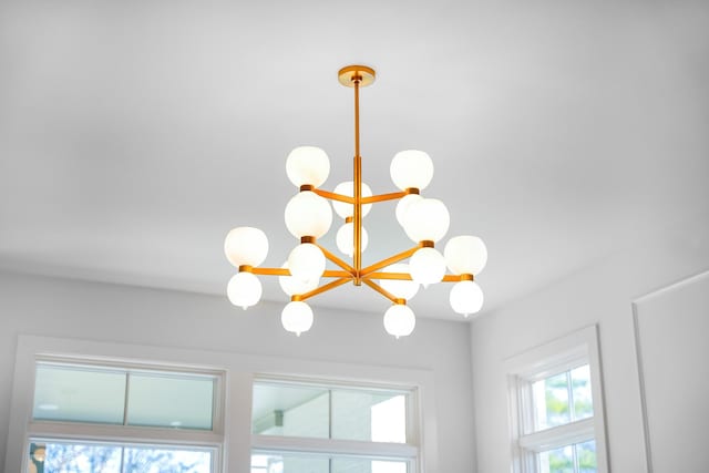 interior details featuring an inviting chandelier