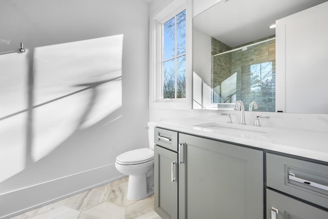 full bathroom featuring a shower with shower door, toilet, marble finish floor, and vanity