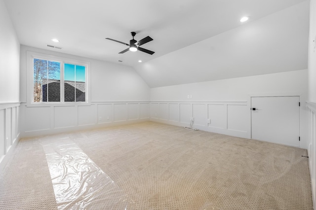 additional living space with visible vents, light colored carpet, lofted ceiling, recessed lighting, and a ceiling fan