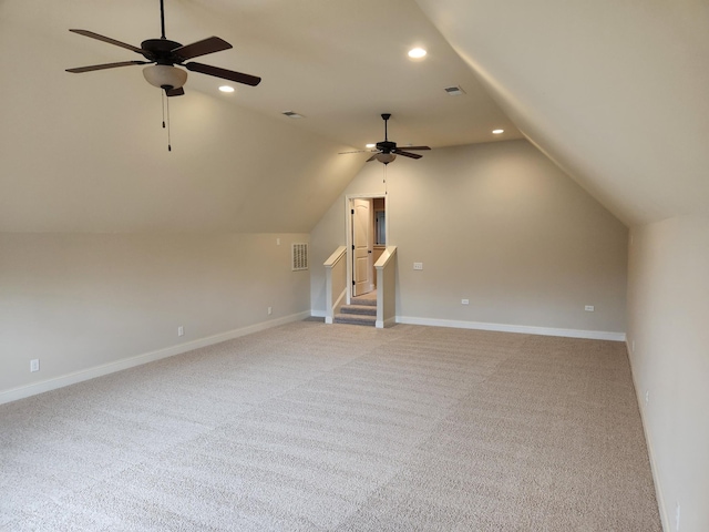 additional living space with lofted ceiling, ceiling fan, light carpet, and visible vents