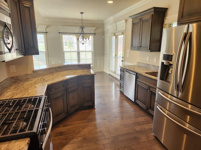 kitchen featuring stainless steel appliances, a notable chandelier, dark wood-type flooring, a decorative wall, and dark brown cabinets